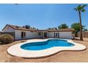 Kidney-shaped pool in a sunny backyard setting at 17052 N 36Th Ct, Phoenix, AZ 85032