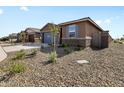 New construction home with stone accents and a neutral color palette at 16077 W Cottontail Ln, Surprise, AZ 85387