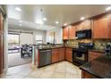 Open kitchen features granite counters, stainless steel appliances, and views into dining area at 21320 N 56Th St # 2145, Phoenix, AZ 85054