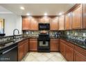 Modern kitchen with granite countertops, dark wood cabinets, and stainless steel appliances at 21320 N 56Th St # 2145, Phoenix, AZ 85054