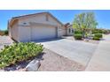 House exterior with a two-car garage and desert landscaping at 2673 E Santa Maria Dr, Casa Grande, AZ 85194