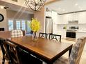 Bright dining room with wooden table and chairs, offering a view of the kitchen and backyard at 7228 E Buena Terra Way, Scottsdale, AZ 85250