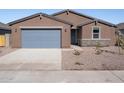 Newly built home features a two-car garage and desert landscaping at 3530 E Alexander Dr, San Tan Valley, AZ 85143