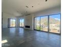 Spacious living room with large windows, tile floors, and a fireplace, offering mountain views at 507 E Mountain View Rd, Phoenix, AZ 85020