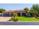 Beautiful home with lush landscaping and a two-car garage at 14147 W Greentree S Dr, Litchfield Park, AZ 85340