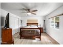 Bright bedroom with a wooden bed frame and ample natural light at 303 S Recker Rd # 45, Mesa, AZ 85206