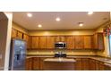 Spacious kitchen with wood cabinets, stainless steel appliances, and an island at 8841 W Cordes Rds, Tolleson, AZ 85353