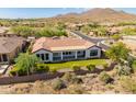Aerial view showcasing house with backyard and surrounding mountain views at 41253 N Whistling Strait Ct, Anthem, AZ 85086