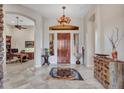Elegant entryway with high ceilings, a chandelier, and a view of the office at 3220 W Feather Sound Dr, Anthem, AZ 85086