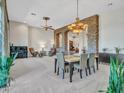 Spacious dining area with a large table and stone accents at 3220 W Feather Sound Dr, Anthem, AZ 85086
