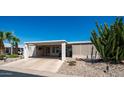 Move-in ready manufactured home with carport and desert landscaping at 215 N Power Rd # 158, Mesa, AZ 85205