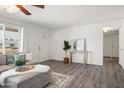 Living room with L-shaped sofa, entryway view, and wood-look floors at 12030 N 36Th St, Phoenix, AZ 85028