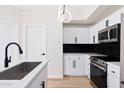 Modern kitchen with island, stainless steel appliances, and white cabinets at 18416 N Cave Creek Rd # 2037, Phoenix, AZ 85032