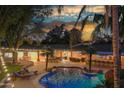 Stunning pool and spa with night lighting and landscaping at 6614 W Sweetwater Ave, Glendale, AZ 85304
