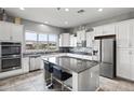 Spacious kitchen with white cabinets, granite countertops, and stainless steel appliances at 41758 W Cribbage Rd, Maricopa, AZ 85138