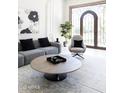 Living room with a large circular coffee table and comfortable seating at 6271 E Horseshoe Rd, Paradise Valley, AZ 85253