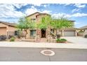 Two-story house with stone accents and landscaped front yard at 26886 N 90Th Ave, Peoria, AZ 85383