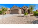 One-story house with a two-car garage and well-maintained landscaping at 17559 W Jessie Ln, Surprise, AZ 85387