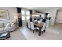 Open concept dining room with adjacent kitchen and living room at 35014 N Sacramento Wash Rd, San Tan Valley, AZ 85144