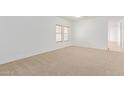 Bright and spacious bedroom with neutral carpeting and large windows at 29759 N Desert Angel Dr, San Tan Valley, AZ 85143