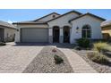 Single-story home with a gray garage door and landscaped front yard at 41301 W Sussex Dr, Maricopa, AZ 85138