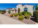 Two-story house with arched entryway, landscaped yard, and driveway at 4142 E Zion Pl, Chandler, AZ 85249