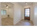 Light and spacious entry hall with wood door and tile floor at 1579 N Himosa Dr, Casa Grande, AZ 85122