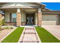 Stunning curb appeal with stone accents and a welcoming porch at 28001 N 92Nd Ave, Peoria, AZ 85383