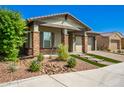 Single-story home with stone accents and a landscaped front yard at 28001 N 92Nd Ave, Peoria, AZ 85383