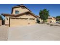 Two-story house with tan exterior, two-car garage, and landscaped yard at 26028 N 66Th Dr, Phoenix, AZ 85083