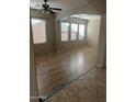 Spacious living room with hardwood floors and large windows at 18527 W Caribbean Ln, Surprise, AZ 85388