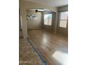 Bright living room featuring hardwood floors and an arched entryway at 18527 W Caribbean Ln, Surprise, AZ 85388