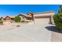 Single-story home with desert landscaping and a two-car garage at 9214 W Kerry Ln, Peoria, AZ 85382