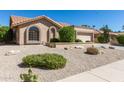Single-story home with a well-manicured front yard at 9214 W Kerry Ln, Peoria, AZ 85382