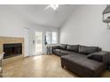 Living room with fireplace, L-shaped sectional sofa, and tiled floors at 19820 N 13Th Ave # 226, Phoenix, AZ 85027