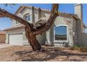 Two-story home with attached garage, mature tree, and gravel landscaping at 10654 E Forge Ave, Mesa, AZ 85208