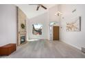 Bright living room with vaulted ceilings, fireplace, and wood-look floors at 10654 E Forge Ave, Mesa, AZ 85208