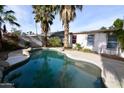 Inviting kidney shaped pool surrounded by palm trees at 307 W Mesquite St, Chandler, AZ 85225