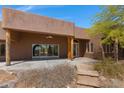 Covered patio with flagstone steps and wooden support beams at 10860 E Cactus View Cir, Gold Canyon, AZ 85118