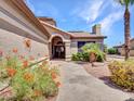 Stone pathway leads to a double door entry with beautiful landscaping at 15802 W Avalon Dr, Goodyear, AZ 85395