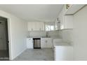 Modern kitchen with white cabinets, gold hardware, quartz countertops, and stainless steel appliances at 568 N Sirrine --, Mesa, AZ 85201
