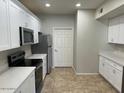 Clean, bright kitchen with white cabinets and stainless steel appliances at 3236 E Chandler Blvd # 1033, Phoenix, AZ 85048