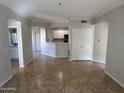 Open living room with tile floors and kitchen bar at 3236 E Chandler Blvd # 1033, Phoenix, AZ 85048