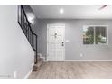 Front entry with staircase, white door and grey walls at 10227 N 7Th Pl # A, Phoenix, AZ 85020