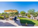 Landscaped backyard with artificial turf and seating area at 4432 W Box Canyon Dr, Eloy, AZ 85131