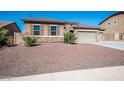 House exterior showcasing stone accents and a two-car garage at 43856 N Hudson Trl, New River, AZ 85087
