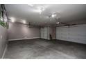 Spacious three-car garage with epoxy flooring and ample storage space at 43856 N Hudson Trl, New River, AZ 85087