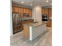 Modern kitchen with island and stainless steel appliances at 5513 W San Gabriel Ave, Laveen, AZ 85339