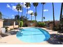 Inviting community pool with lounge chairs and palm trees at 23014 N 86Th St, Scottsdale, AZ 85255