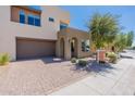 Modern home exterior with two-car garage and landscaping at 36131 N Desert Tea Dr, Queen Creek, AZ 85140